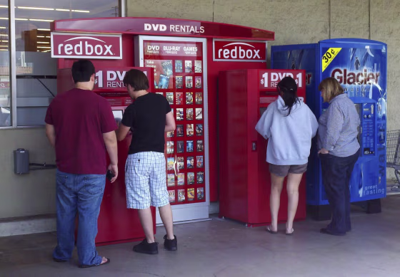 Image: Customers rent DVD movies from a redbox video kiosk
