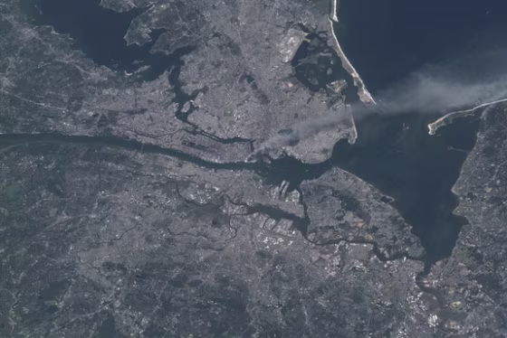 One of a series of pictures of metropolitan New York City taken by one of the crew members onboard the International Space Station&nbsp;at various times during the day on Sept. 11, 2001. A smoke plume rises from the Manhattan area where the World Trade Center was destroyed. The orbital outpost was flying at an altitude of about 250 miles.