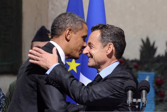 Image: US President Barack Obama (L) hugs his French counterpart Nicolas Sarkozy during a ceremony at a World War I memorial in Cannes on November 4.