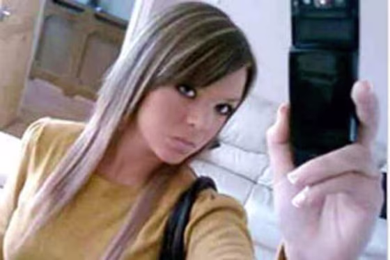 Teenage girl takes picture of self in mirror