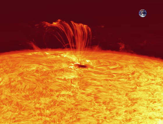 French skywatcher Jean-Pierre Brahic took this photo of the violent solar flare from the sunspot 1302 on the sun's surface on Sept. 22. Earth is superimposed for scale.