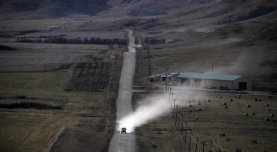 Image: Vehicle drives along dirt road in Stanley, N.D.