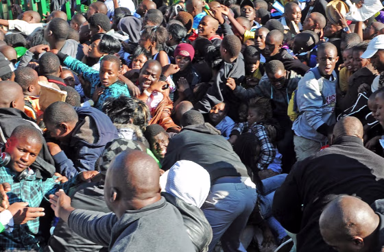 Image: Thousands of young students and their parents push their way into the gates causing a stampede at the University of Johannesburg