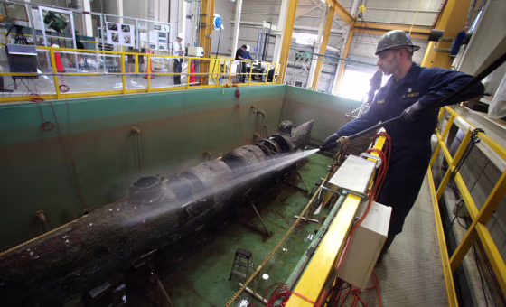 Image: Senior conservator Paul Mardikian wets down the Civil War submarine H.L. Hunley after it was freed of the steel truss that was used to raise it from the ocean floor in 2000.