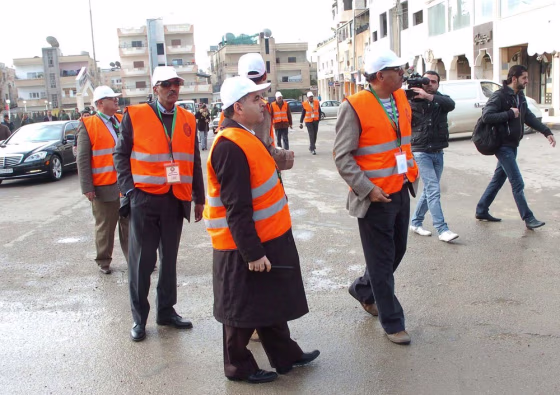 Image: In this photo released by Syria's official news agency, Arab League monitors check Al-Sabil area, in Daraa, Syria