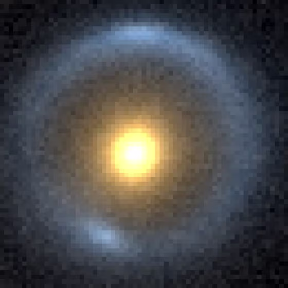 This false-color photo shows an "Einstein ring," a visual effect caused by gravitational lensing of a distant galaxy by a massive intervening one. In this system, called B1938, a small invisible dwarf galaxy is adding minor disturbances to the gravitational lensing.