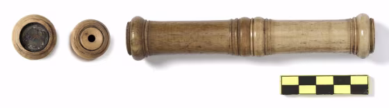 The longest of the telescopes discovered, about 5 inches (140 mm) long and made of cow metatarsal bone, has two finely crafted parts held together with a screw thread. At far left, a lens of the telescope, next to a device with a hole that functioned as an aperture stop.