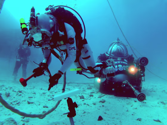 NASA astronaut Dottie Metcalf-Lindenburger tests ways to anchor to the surface of an asteroid on a simulated spacewalk on the ocean floor during the NEEMO 16 mission.