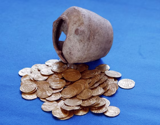 Image: Gold coins and the jar within which they were unearthed during excavations at a Crusader fortress, are displayed near Herzliya