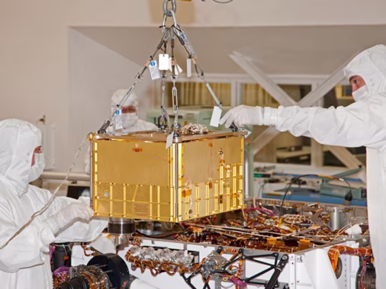 Technicians and engineers carefully install the 88-pound (40-kilogram) SAM instrument on the Curiosity rover. The picture was taken at NASA's Jet Propulsion Laboratory, Pasadena, Calif., on Jan. 6, 2011.