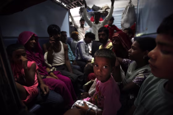 Image: Passengers sit in a train and wait for power to get restored at a railway station in New Delhi, India.