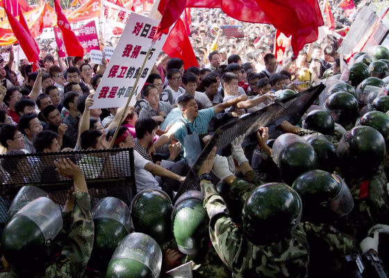 Image: Chinese demonstrators clash with policemen at the barricades during an anti-Japan protests