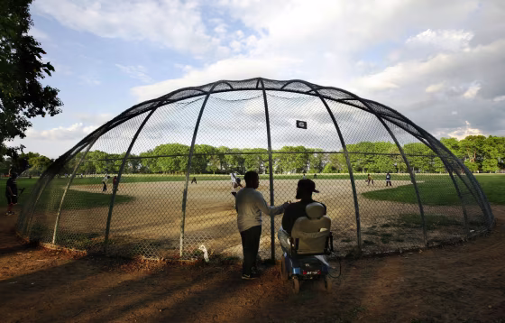 Newark Eagles Little League team player William Jones gives Coach Rodney Mason a high-five as he arrives at practice at the practice field at Weequahic Park on May 15, 2008.