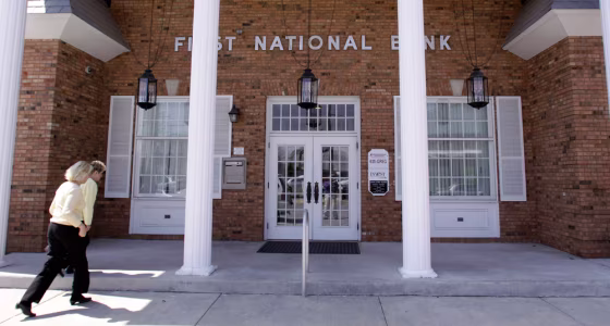 Image: People enter First National Bank in Staunton, Ill.
