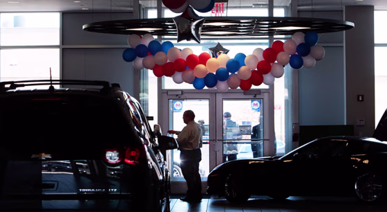 Image: A man stands in the showroom of the Chevrolet-Saturn dealership in New York City in June.