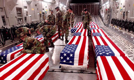 Image: US military personnel offloading coffinsof US soldiers killed in Iraq at DoverAir Base in Delaware