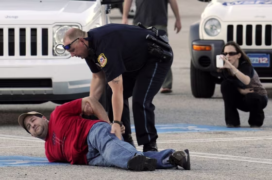 Image: Opelika police take a suspect into custody at Southern Union Community College on Wednesday, April 6, 2011, in Opelika, Ala.