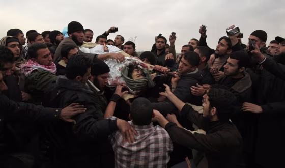 Image: Palestinians carry the body of militant Abu Daf during his funeral in Gaza