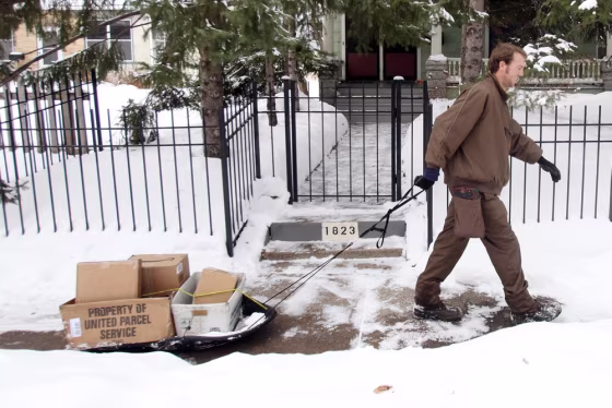 Image: UPS employee pulls a sled
