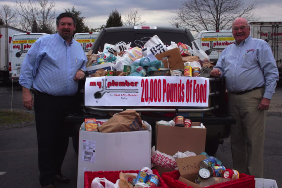 Mark and Wendell Presgrave with some of the collected food that will be distributed to needy people in the D.C. metropolitan area.
