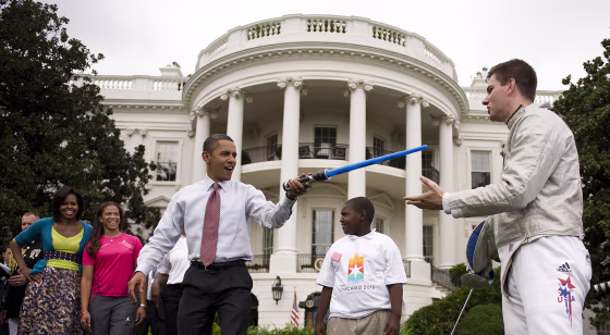 President Barack Obama attacks Fencer Tim Morehouse with a lightsaber during an event on Olympics, Paralympics and youth sport on the South Lawn of the White House on Wednesday.