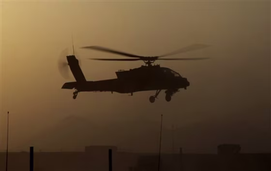 A&nbsp;U.S. Army Apache attack helicopter takes off after refueling during a several-hour firefight against the Taliban, in Zhari district, Kandahar province, southern Afghanistan, late Friday, Aug. 20.