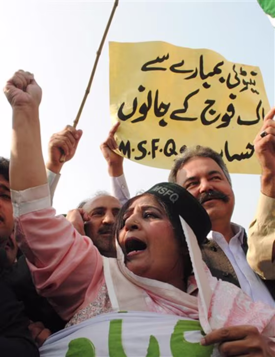 A Pakistani woman joins others to condemn NATO strikes on Pakistani posts, in Peshawar, Pakistan on Monday. The NATO airstrikes that killed 24 Pakistani soldiers went on for almost two hours and continued even after Pakistani commanders had pleaded with coalition forces to stop, the army claimed Monday in charges that could further inflame anger in Pakistan. A placard reads "NATO is responsible for the loss of Pakistani soldiers."