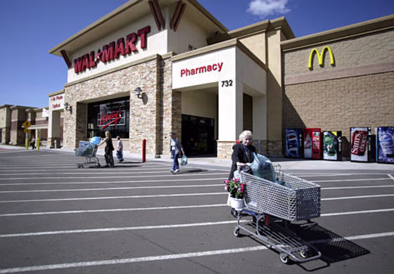 Shoppers exit a Wal-Mart store in San Marcos , Calif. The world's largest retailer blocked a proposed ban of its superstores in Contra Costa County, Calif., but lost a vote that could allow it to open another store in San Marcos. It has faced strong opposition in California to its strong plans for expansion.