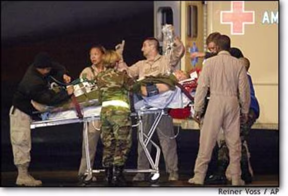 A wounded Canadian soldier is helped into an ambulance at the Ramstein U.S. Air Base in Germany. 