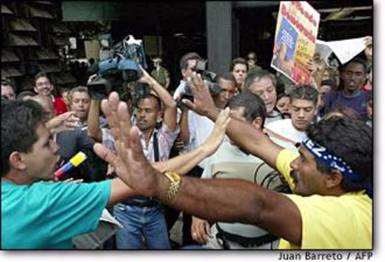 Supporters and opponents of Venezuelan President Hugo Chavez confront each other outside the attorney general's office in Caracas on Friday.