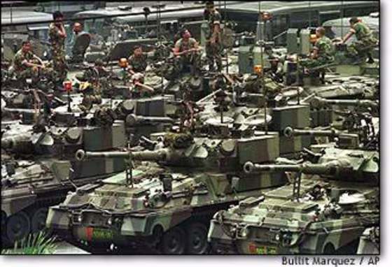 Indonesian soldiers relax on their armoured personnel carriers at the Kostrad, the army's strategy center in Jakarta on Saturday.