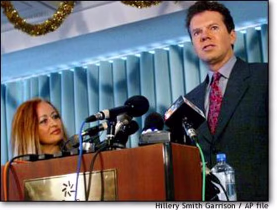 Michael Guillen, right, a former science editor, speaks last week as Brigitte Boisselier of Clonaid looks on in Hollywood, Fla. Guillen said Monday efforts to conduct DNA tests on the alleged clone baby have been canceled.
