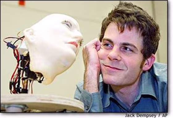 Researcher David Hanson gazes at K-Bot, the expressive robo-face he created from $400 worth of parts and a material he calls "F'ubber."