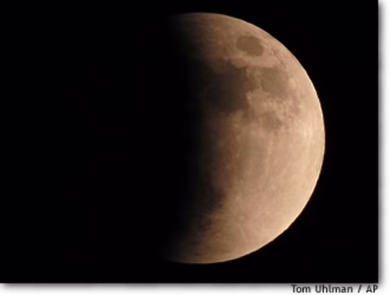 Saturday night's lunar eclipse turns the moon red, as seen from the Cincinnati Observatory. Hundreds lined up to peer through the observatory's telescope and others that were brought by amateurs.