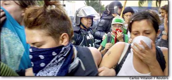 Miami police use pepper spray Thursday to disperse a crowd on Biscayne Boulevard protesting a meeting of the Free Trade Area of the Americas group.