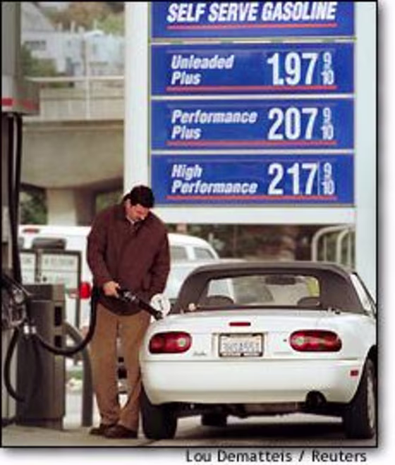 A motorist fills his tank at a San Francisco service station Tuesday.