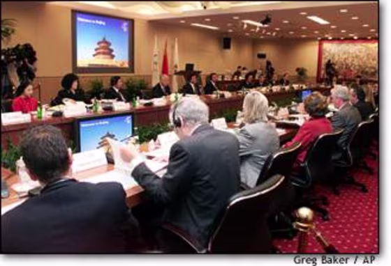Members of the International Olympic Committee listen to the first presentation by the Beijing Olympic Bid Committee's bid for the 2008 Olympic Games on Wednesday.
