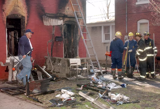 Authorities work Sunday afternoon outside the home where five children died in a house fire, that morning, in Quincy, Ill. Zachary Q. Meeks, 27, has been charged with five counts of first-degree murder in connection with&nbsp;the early morning fire.