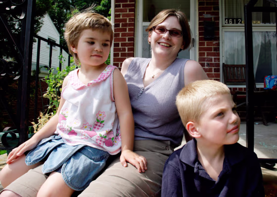 Image: Julie Jacobs with her two children who won't be taking their beach vacation this year