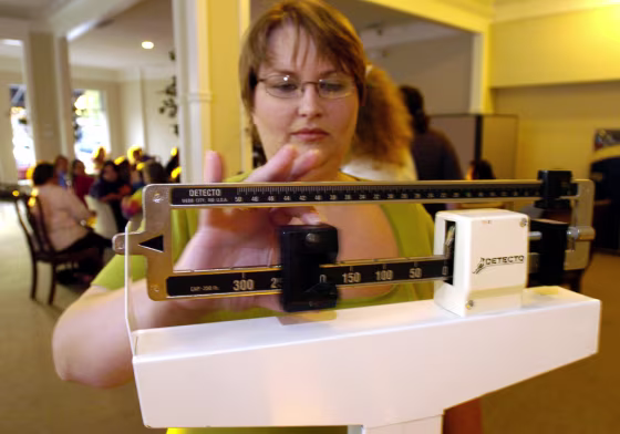Image: Jamie Wright checks her weight loss