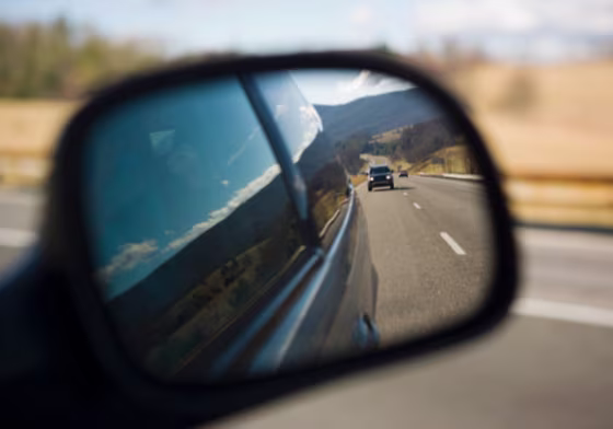 Image: Car reflecting in side view mirror