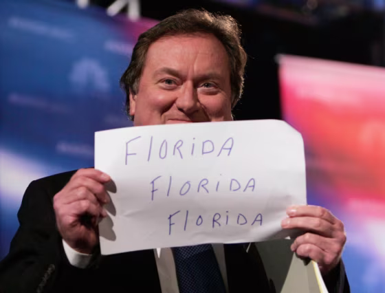 File photo of NBC talk show host Russert holding sign as he takes the stage at Florida Atlantic University in Boca Raton