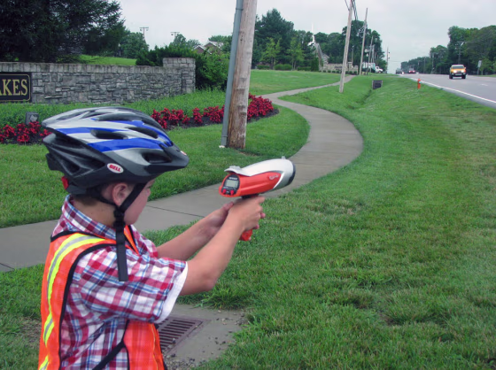 Image: Landon Wilburn, 11, points his Hot Wheels brand radar gun