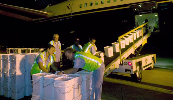 Image: Ground crew members unloading more than 17 tons of silver coins