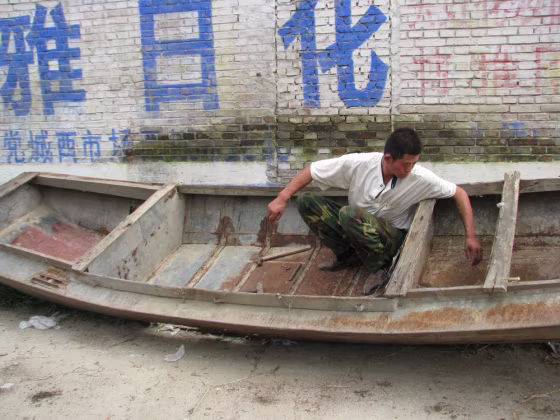 Cheng Linpeng, 34, a migrant worker in Beijing had to leave the city on July 20 because his project was shut down due to pollution concerns ahead of the Olympic Games. He's returned to his hometown of Zhengjiazhuang and is trying to repair an old boat that he hasn't used in several years because all the waterways near his house have dried up.