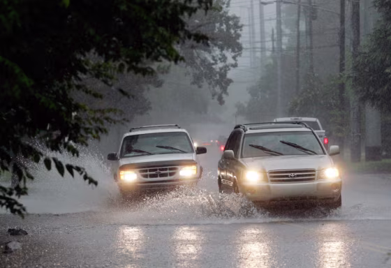 Image: Traffic passes through street flooding
