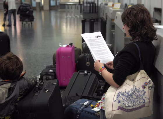 Image:A  passenger holding a statement provided by Zoom Airlines