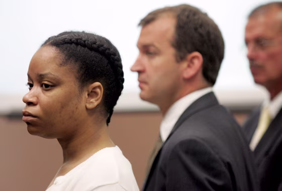China Arnold, left, in court on Wednesday with&nbsp;her lawyers, Jon Paul Rion, center, and Kevin Lennen. She chose not to be in the courtroom during her sentencing on Monday.