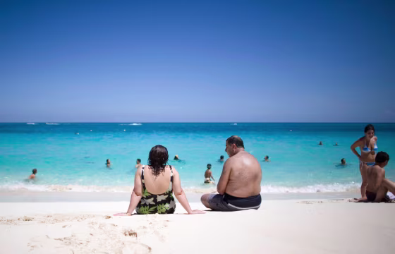 Image: Tourists sunbathe