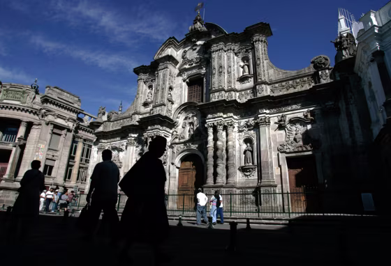 Image: People walk by La Compania de Jesus church in Quito, Ecuador